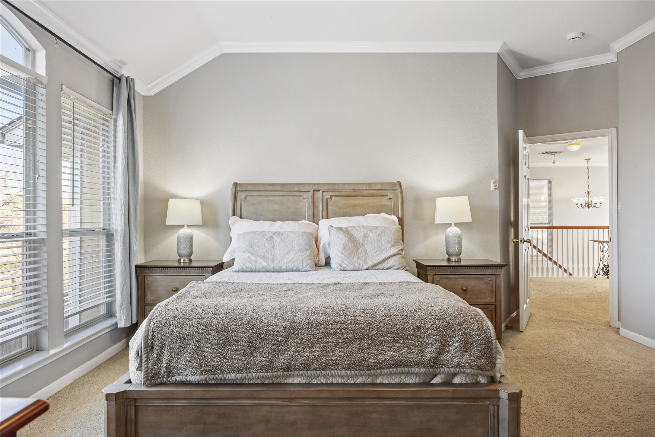 122 Summers Green Georgetown, TX 78633 - Photo 13 of 22 Bedroom featuring ornamental molding, light carpet, and hanging lights