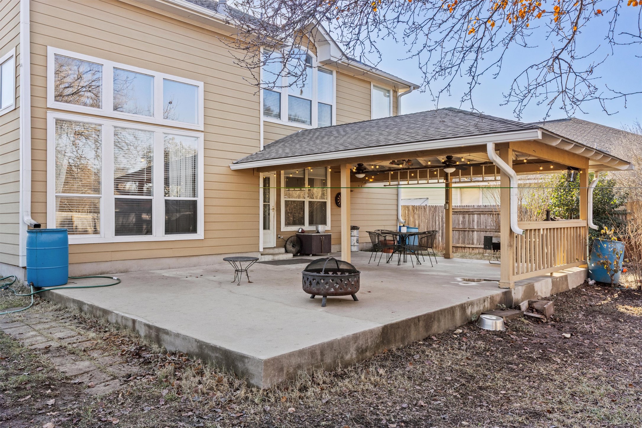 122 Summers Green Georgetown, TX 78633 - Photo 8 of 22 Back of house with roof with shingles, a ceiling fan, a fire pit, and a patio