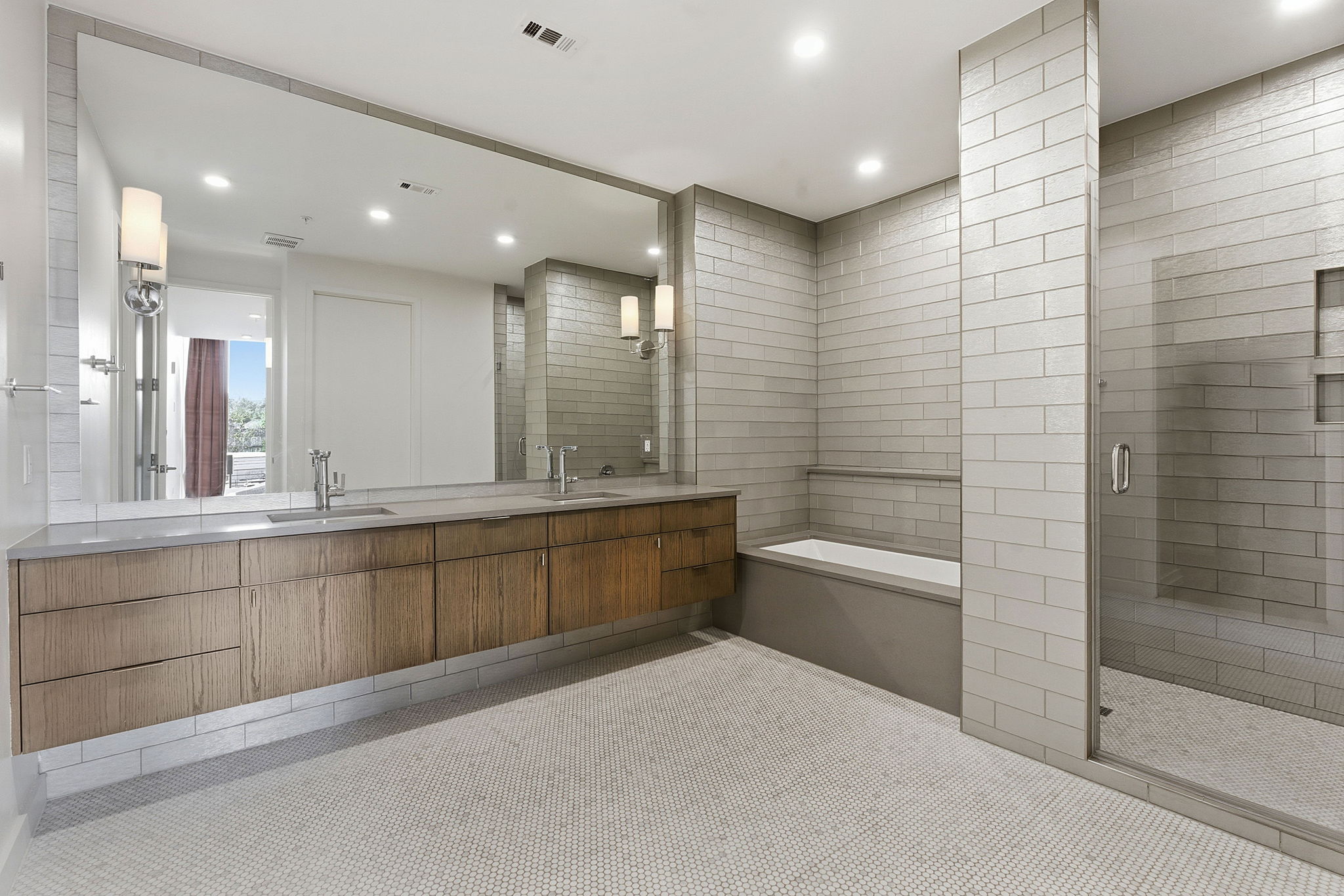 1010 West 10th Street, Unit 203 Austin, TX 78703 - Photo 11 of 20 a bathroom with a granite countertop sink a toilet a mirror and bathtub