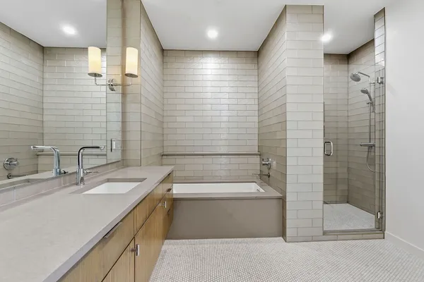 a bathroom with a double vanity sink toilet and shower