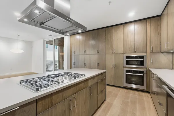 a kitchen with a stove and a refrigerator