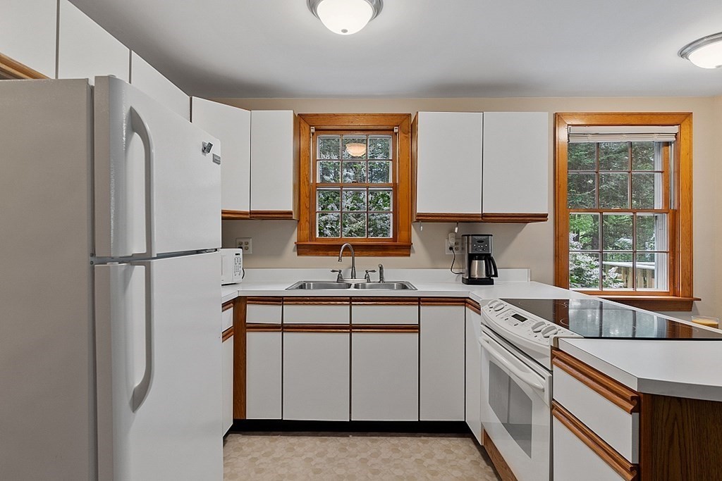 187 Red Acre Road Stow, MA 01775 - Photo 18 of 27 a kitchen with white cabinets and white appliances