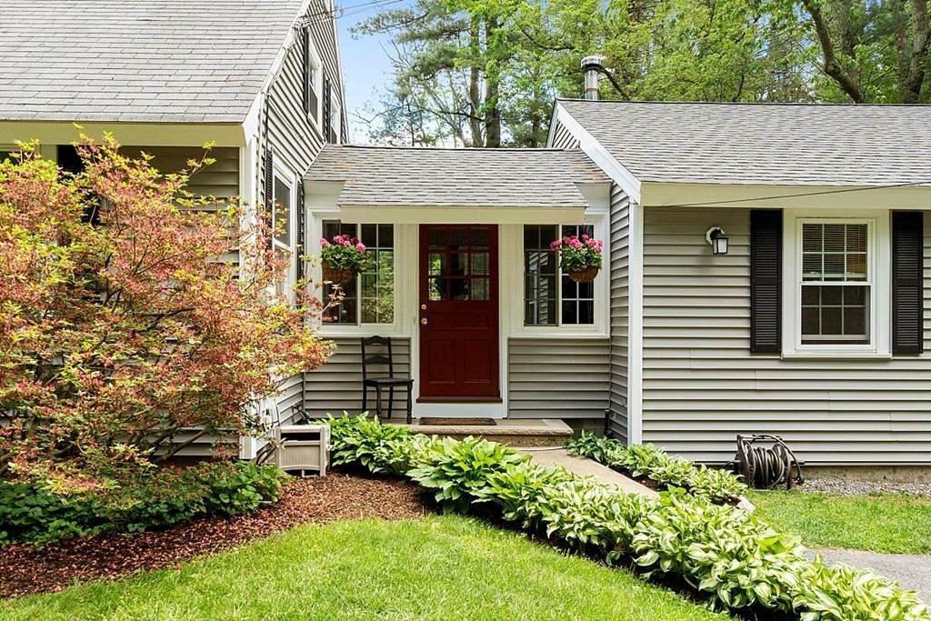 187 Red Acre Road Stow, MA 01775 - Photo 2 of 27 a view of a house with a small window and a yard with plants