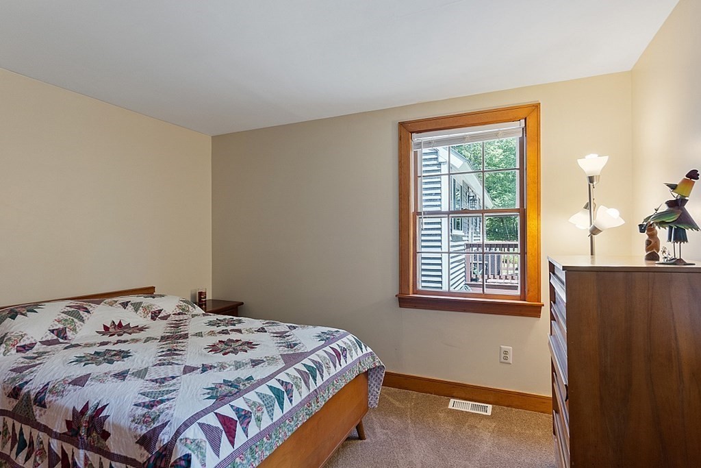 187 Red Acre Road Stow, MA 01775 - Photo 22 of 27 a bedroom with a bed and wooden floor