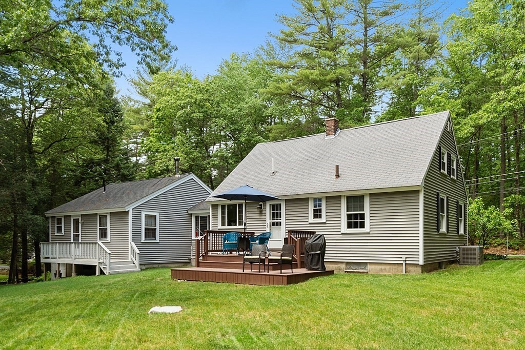 187 Red Acre Road Stow, MA 01775 - Photo 23 of 27 a front view of a house with a garden and sitting area
