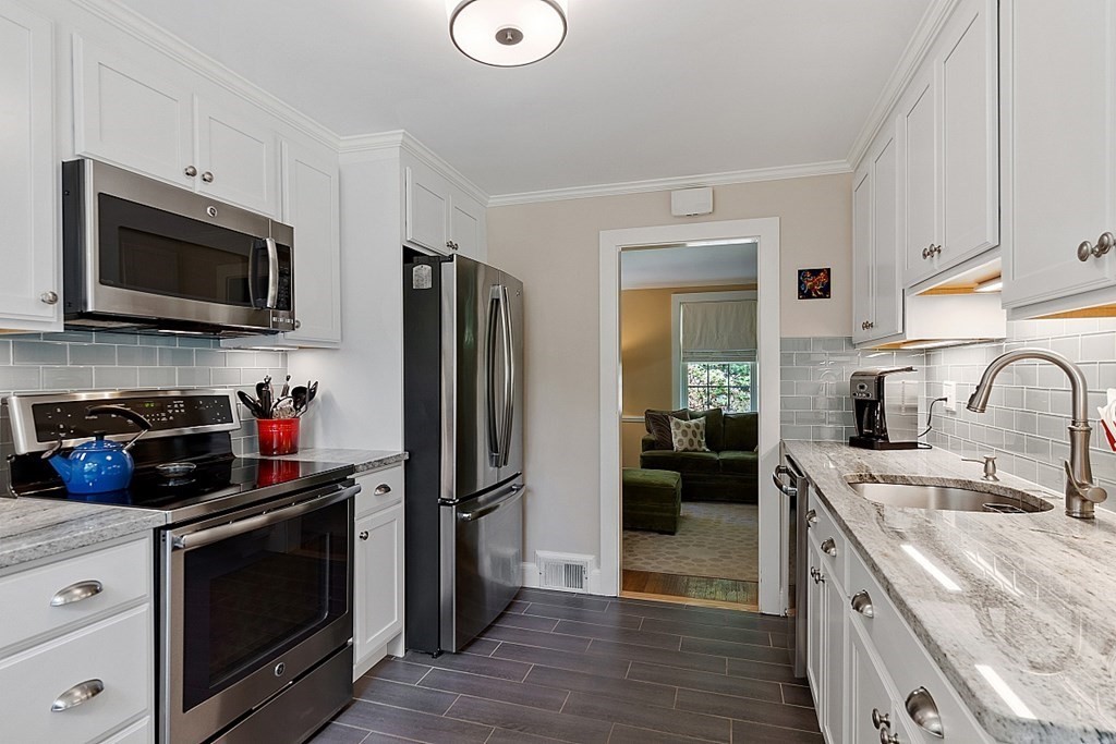 187 Red Acre Road Stow, MA 01775 - Photo 6 of 27 a kitchen with stainless steel appliances granite countertop a refrigerator stove and sink
