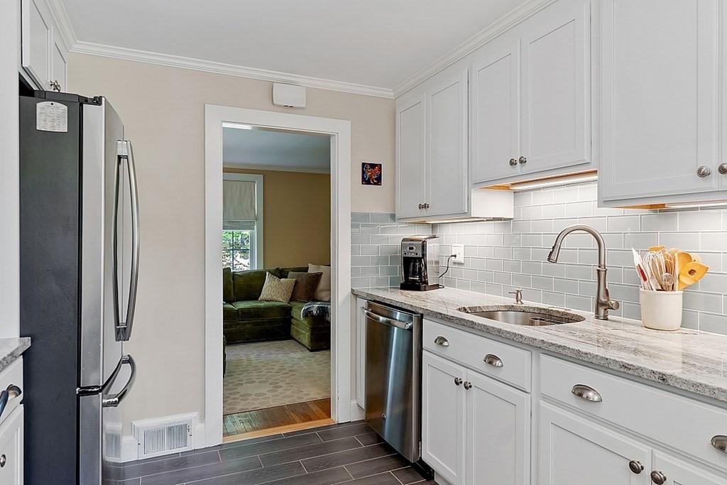187 Red Acre Road Stow, MA 01775 - Photo 8 of 27 a kitchen with stainless steel appliances granite countertop a refrigerator sink and white cabinets