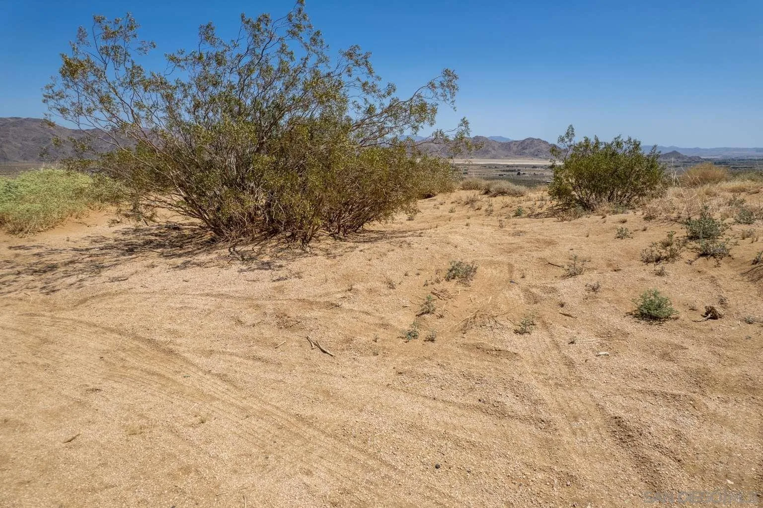 0 Joshua Road Lucerne Valley, CA 92356 - Photo 22 of 40 a view of a dry yard with a house in the background