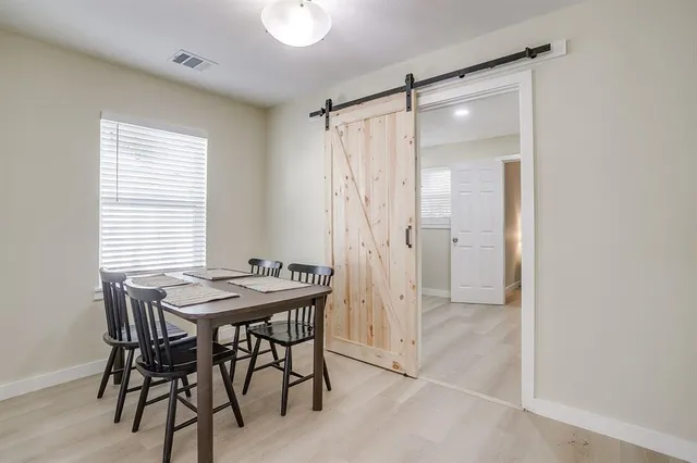 a kitchen with a table chairs and a refrigerator