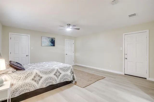 a bedroom with a bed and a night stand