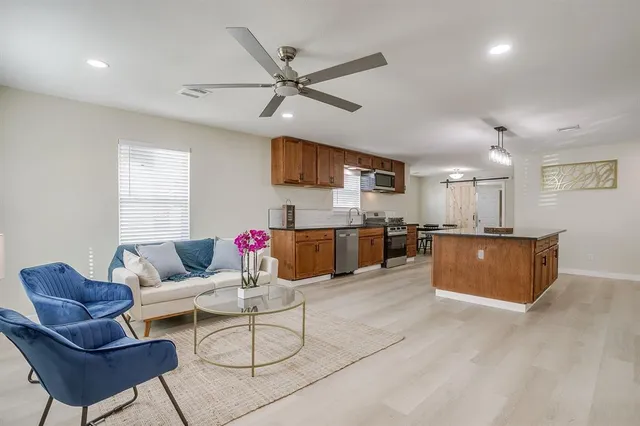 a living room with furniture and a wooden floor
