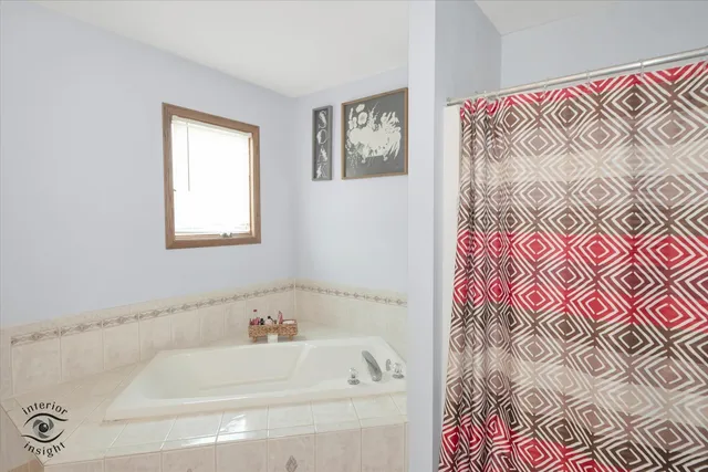 a bathroom with a bathtub and a shower