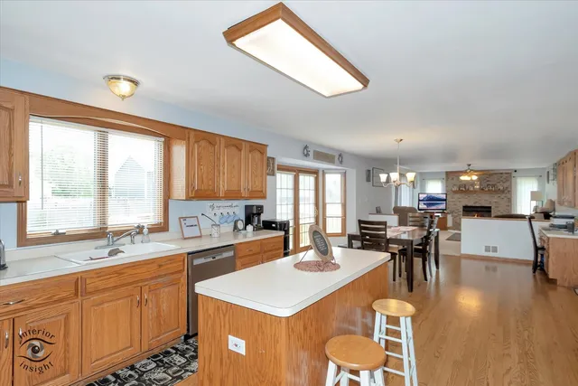 a large kitchen with lots of counter space a sink appliances and dining table