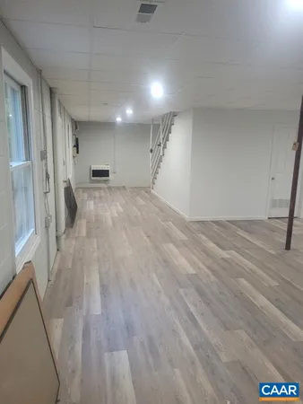 a view of empty room with wooden floor
