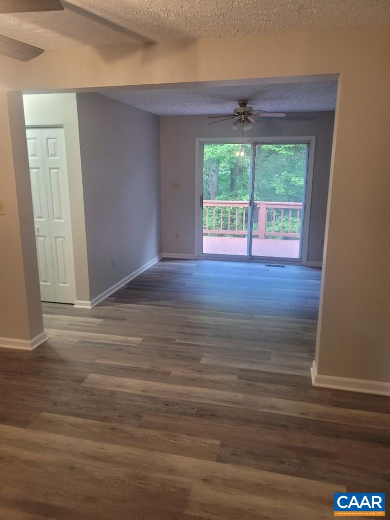 906 Equestrian Trail Road New Canton, VA 23123 - Photo 4 of 22 a view of an empty room with wooden floor and a window