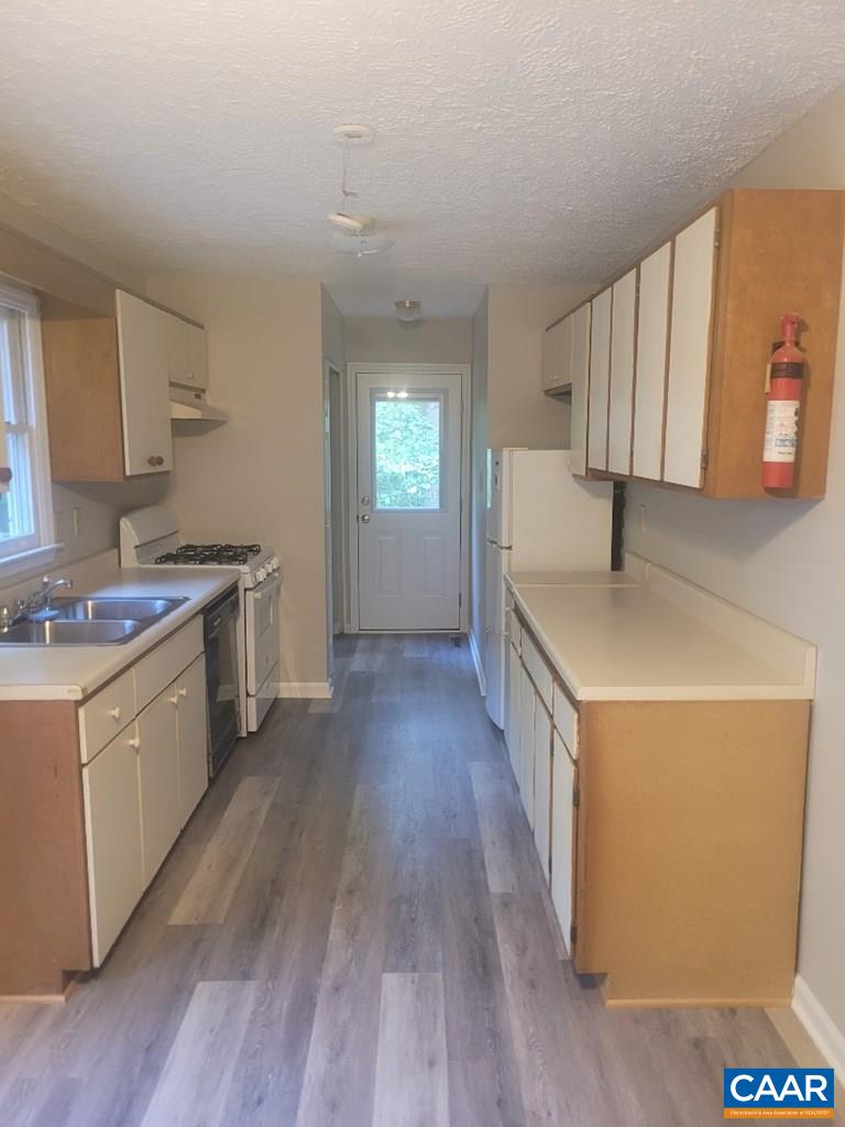 906 Equestrian Trail Road New Canton, VA 23123 - Photo 6 of 22 a kitchen with a sink stove and a refrigerator