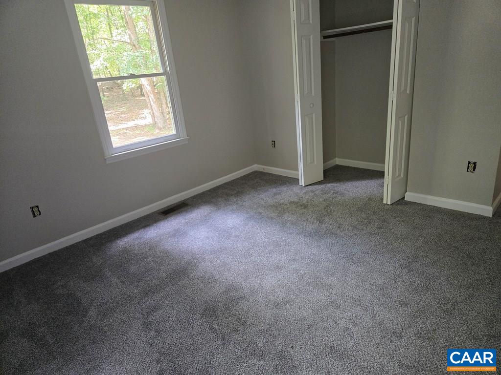 906 Equestrian Trail Road New Canton, VA 23123 - Photo 8 of 22 an empty room with a window