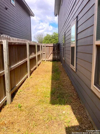 a view of balcony with wooden floor and fence