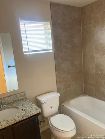 a bathroom with a sink a toilet and bathtub