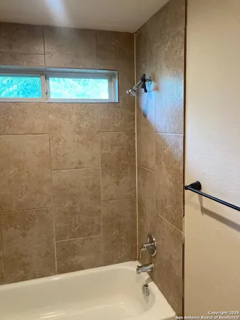 a bathroom with a shower and a bathtub