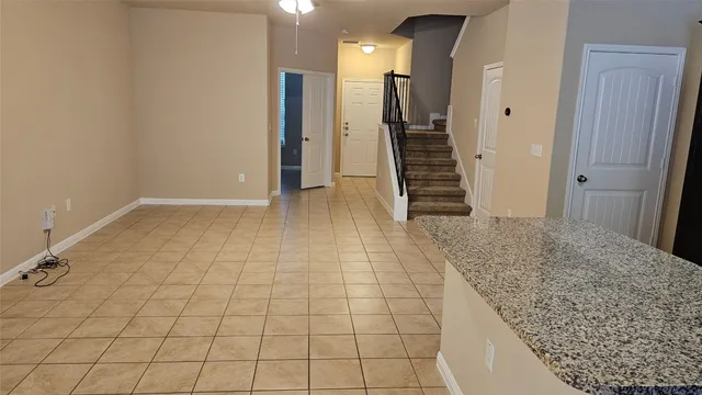 a view of hallway with stairs and wooden floor