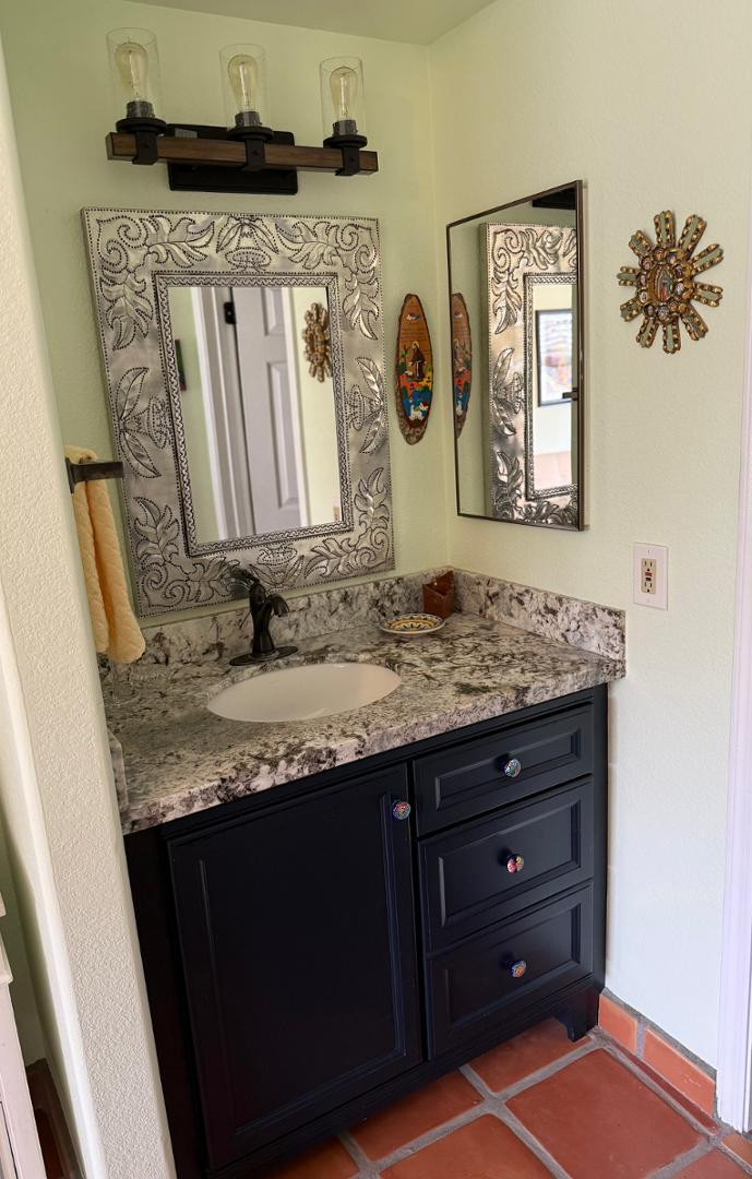 1825 West Ray Road, Unit 1012 Chandler, AZ 85224 - Photo 15 of 34 a bathroom with a granite countertop sink and a mirror
