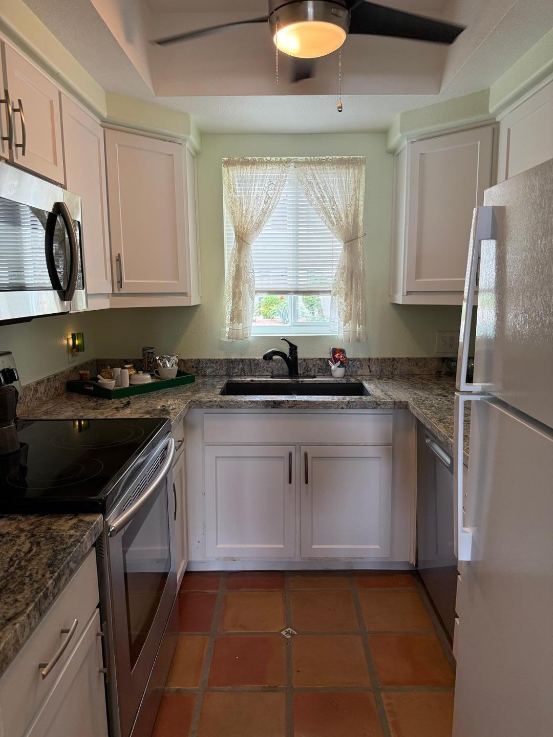 1825 West Ray Road, Unit 1012 Chandler, AZ 85224 - Photo 17 of 34 a kitchen with a sink a stove and refrigerator