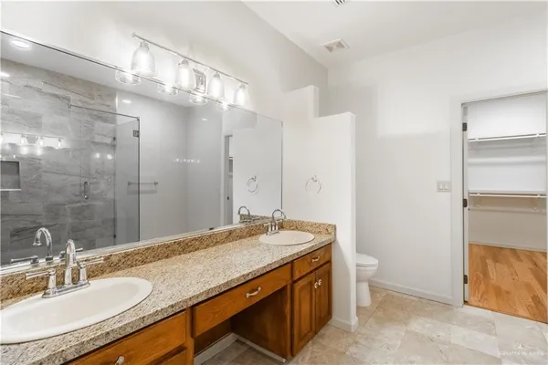 a bathroom with a granite countertop sink a mirror and a bathtub