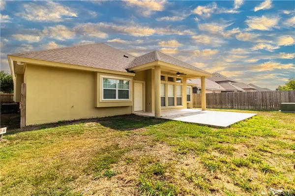 a view of a house with swimming pool and a yard