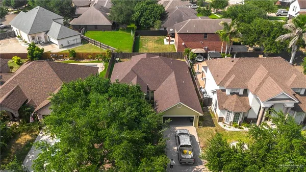 an aerial view of residential houses with outdoor space and street view