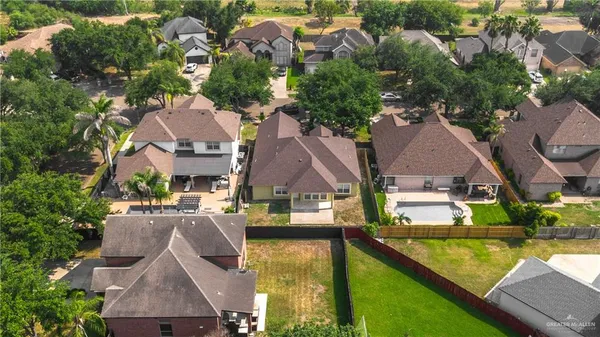 an aerial view of residential houses with outdoor space and swimming pool