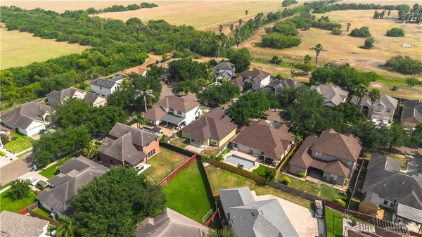 an aerial view of multiple houses with yard