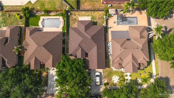 an aerial view of a house with a yard and garden