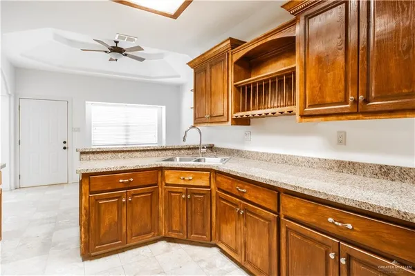 a kitchen with granite countertop a sink and cabinets