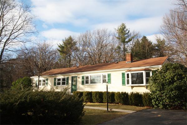 3 Garland Road Chelmsford, MA 01824 - Photo 1 of 1 a front view of a house with a garden and trees