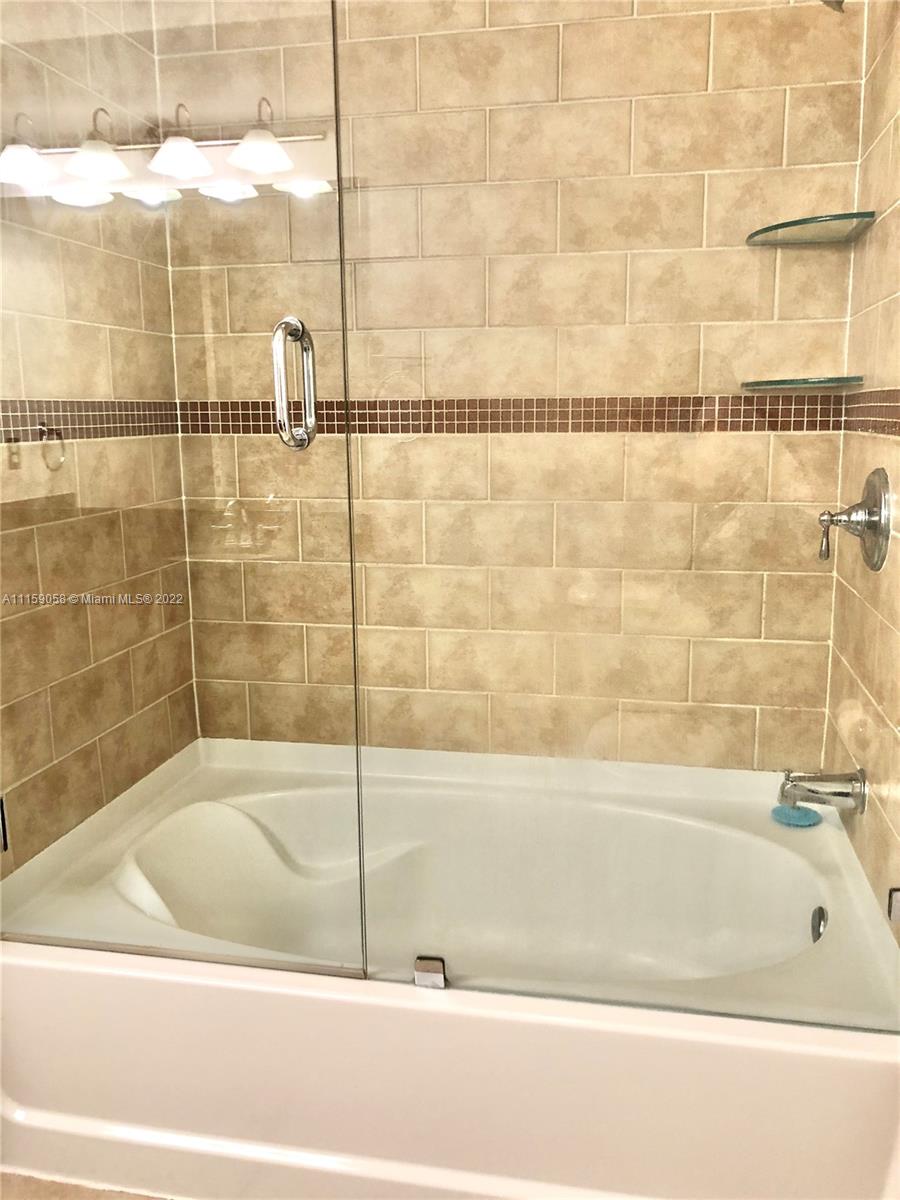 7371 Southwest 90th Street, Unit TH106S Miami, FL 33156 - Photo 12 of 25 a bathroom with a bathtub and shower