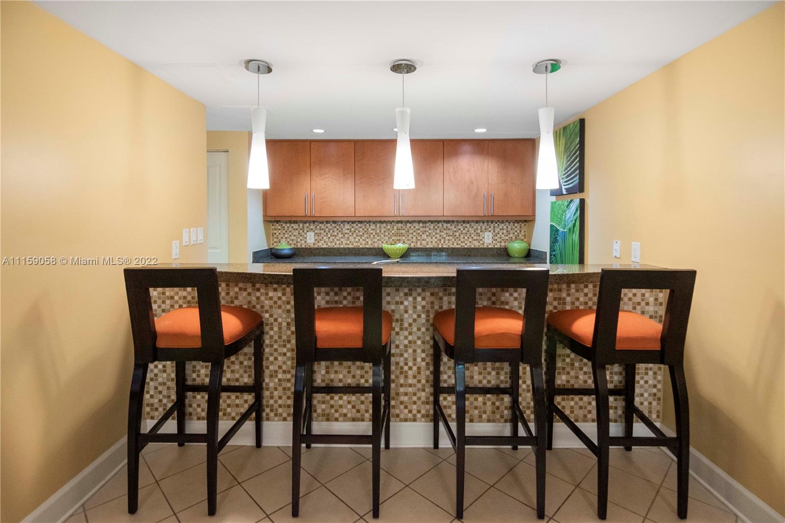 7371 Southwest 90th Street, Unit TH106S Miami, FL 33156 - Photo 22 of 25 a kitchen with a dining table chairs cabinets and stainless steel appliances