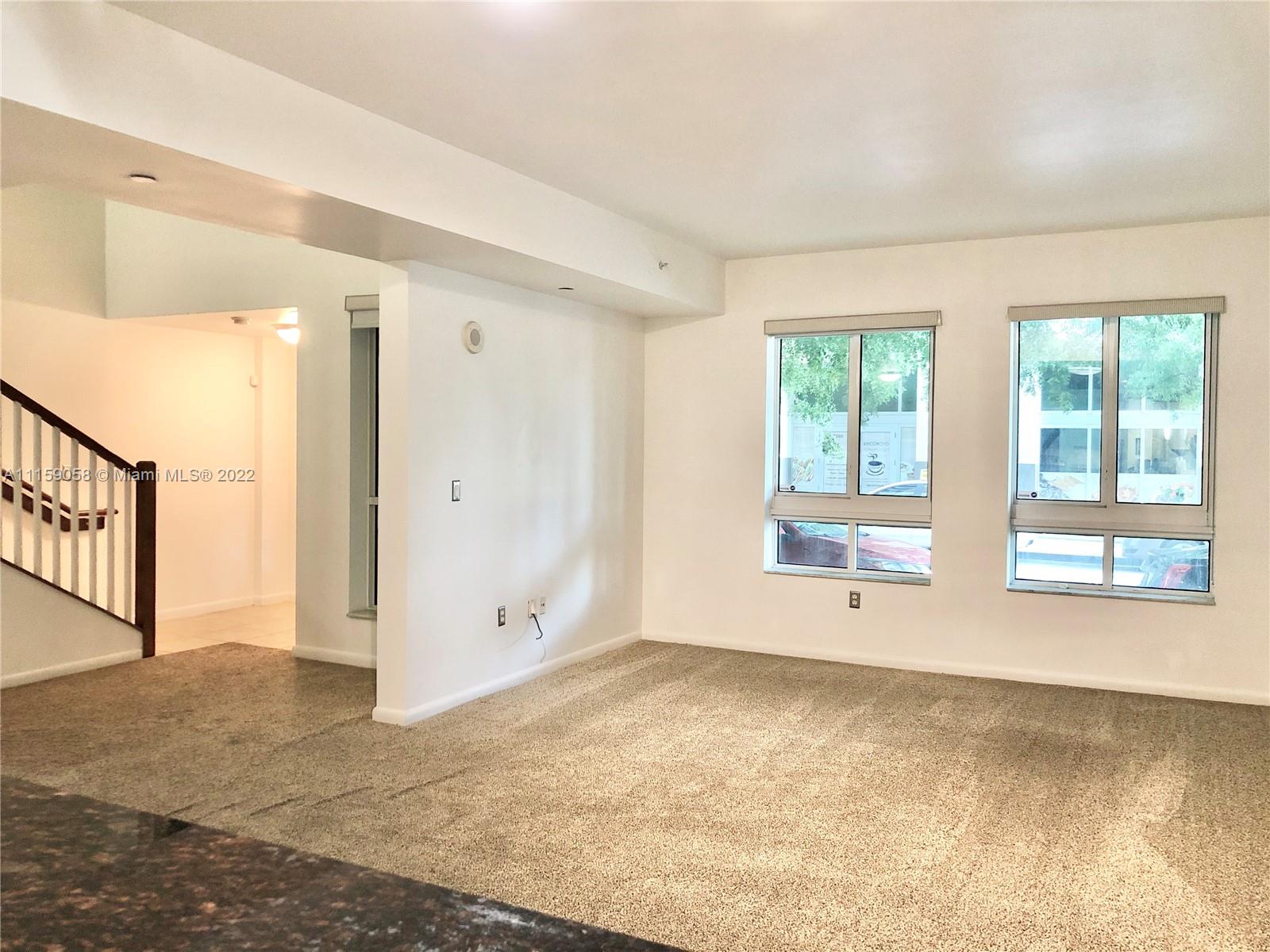 7371 Southwest 90th Street, Unit TH106S Miami, FL 33156 - Photo 7 of 25 a view of an empty room with a window