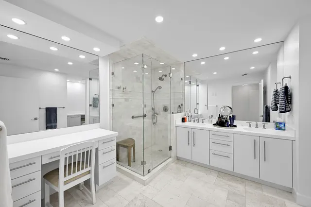 a spacious bedroom with a bed and a flat screen tv