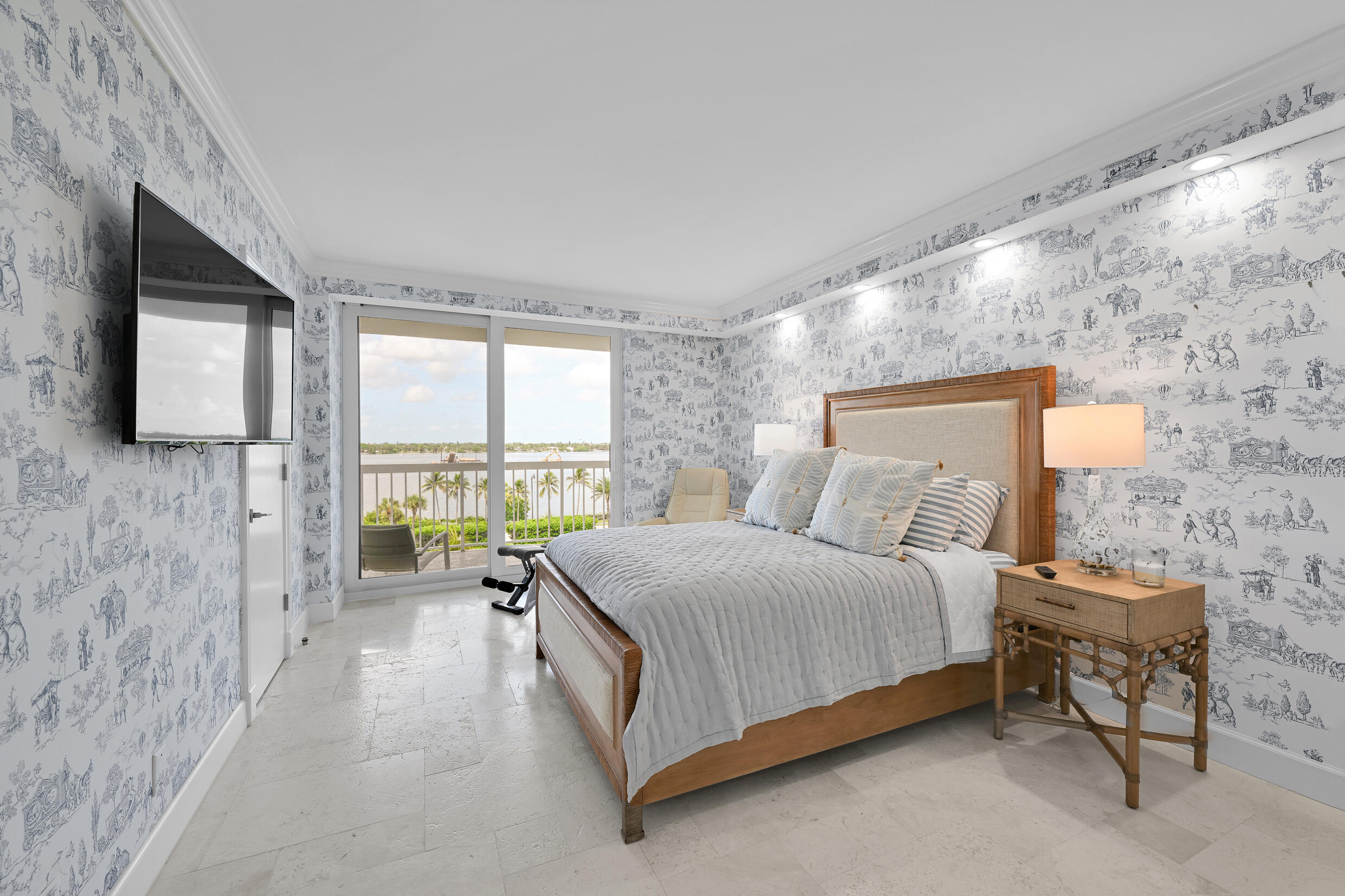 3300 South Ocean Boulevard, Unit 508S Palm Beach, FL 33480 - Photo 13 of 28 a spacious bedroom with a bed and a flat screen tv