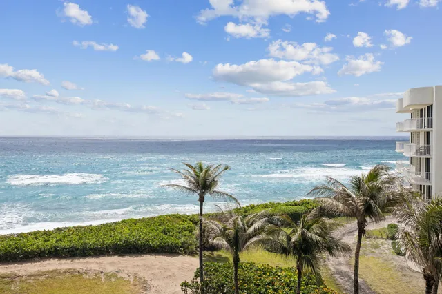 a view of a balcony with two chairs and a table