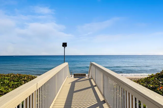 a view of swimming pool with outdoor seating and plants