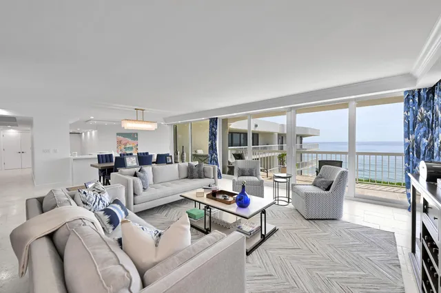 a living room with furniture and large windows