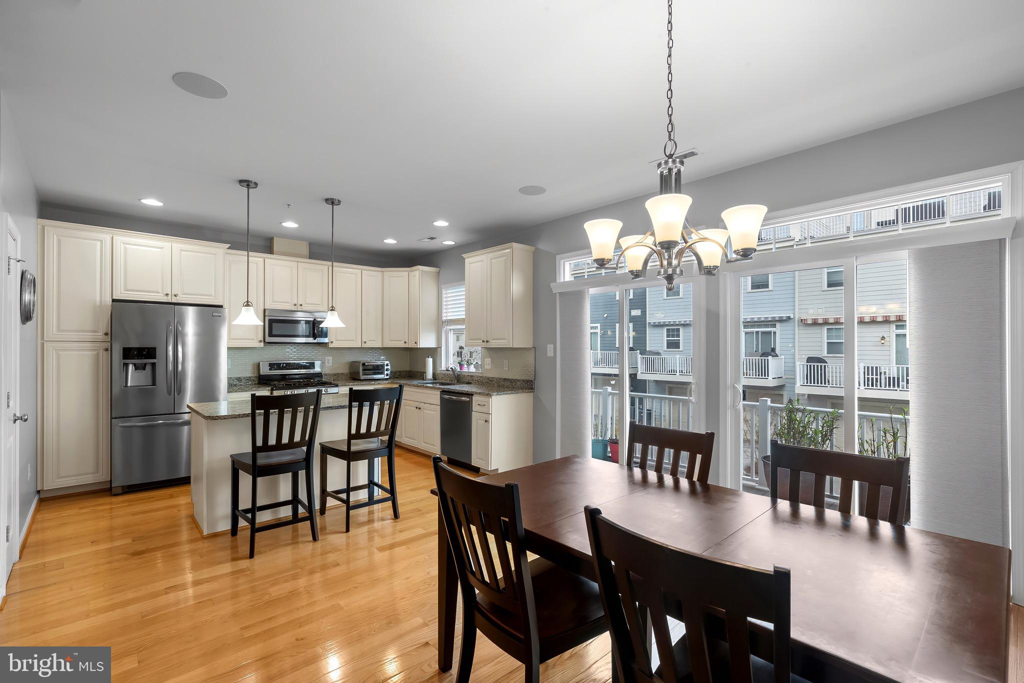 2065 Case Road Baltimore, MD 21222 - Photo 11 of 48 a kitchen with stainless steel appliances kitchen island granite countertop a dining table chairs and a refrigerator
