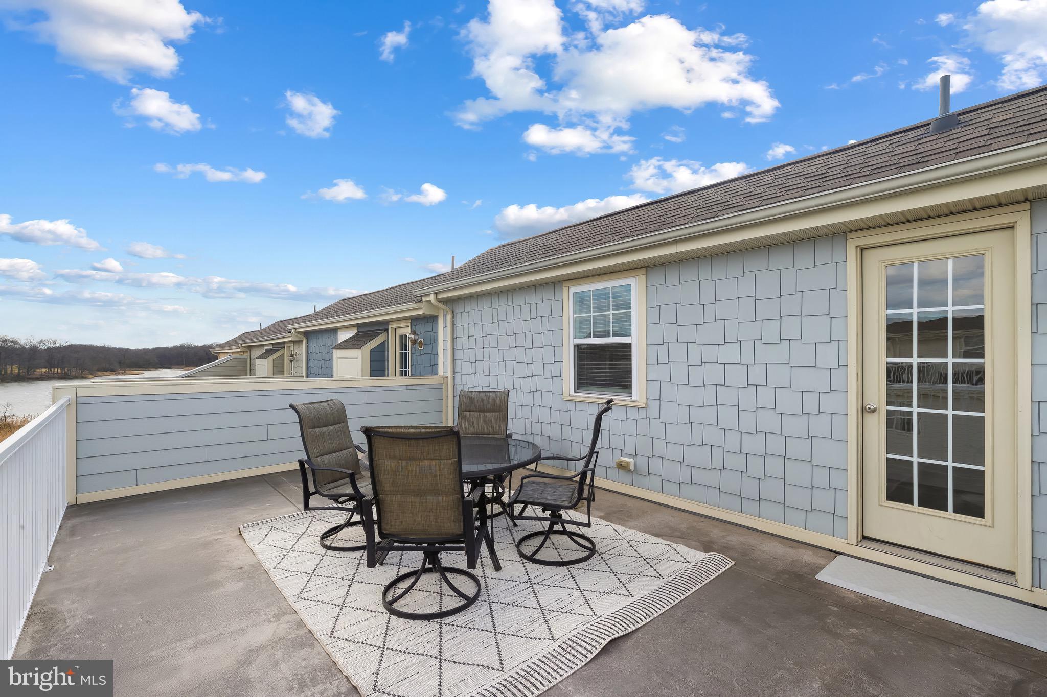 2065 Case Road Baltimore, MD 21222 - Photo 29 of 48 a view of a patio with table and chairs with wooden floor and fence