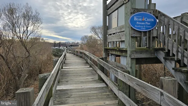 a view of a dry yard with wooden fence