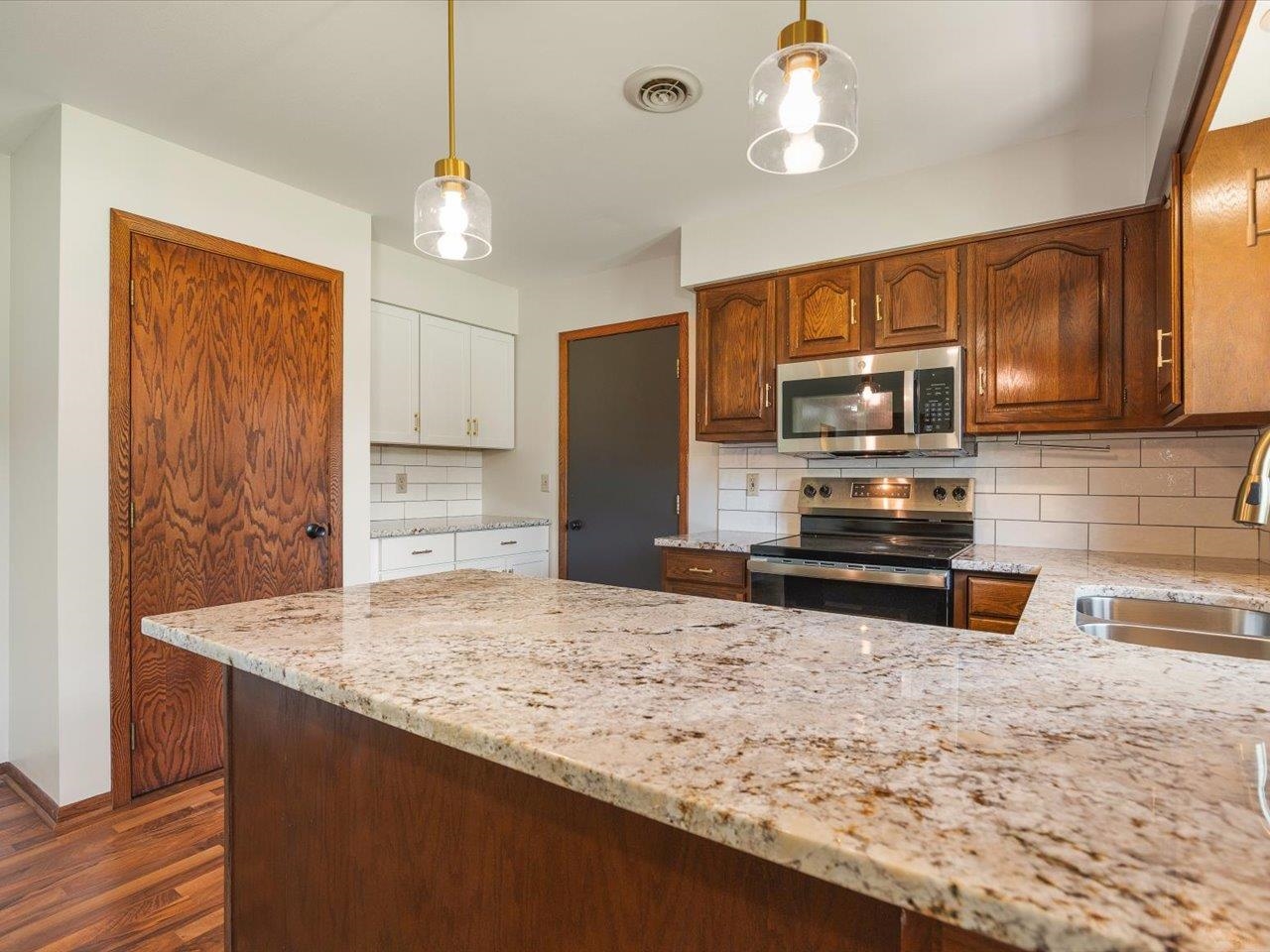 136 Lake Summerset Road Lake Summerset, IL 61019 - Photo 5 of 47 a kitchen with stainless steel appliances granite countertop a sink refrigerator and microwave