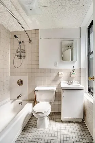 a view of a kitchen with microwave and windows