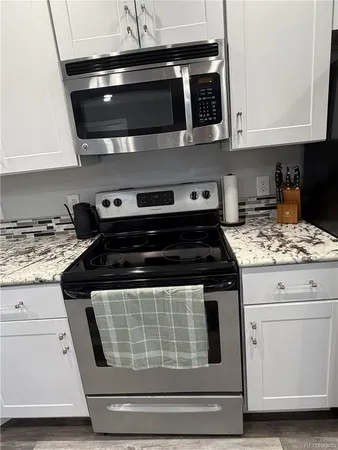 a stove top oven sitting inside of a kitchen