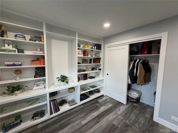a view of walk in closet with clothes and shoes
